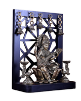 Front view of brass Saraswati idol with veena, ornate crown, and hanging bells