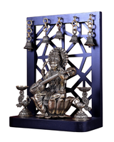 Brass Saraswati idol holding veena, seated on lotus, with lamp stands and bells