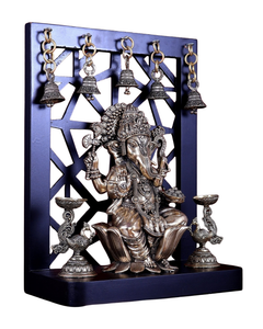 Brass Ganesha idol with raised hands, detailed jewelry, flanked by two oil lamps