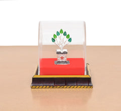 White metal Tulsi plant idol in clear display dome on black base with gold trim