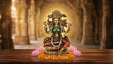 Lakshmi resin idol with ornate golden halo, green torso, red patterned skirt, lotus seat