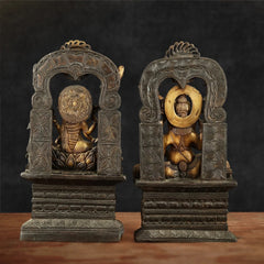 Back view of antique brass Chola Lakshmi and Ganesh idols with arched halo