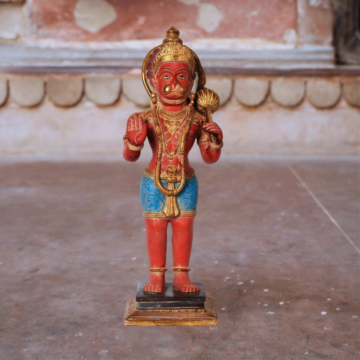 Brass Hanumanji idol in red with blue dhoti, hands raised in blessing gesture