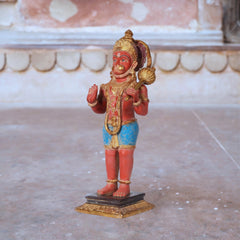 Brass Hanumanji idol, side view, red body with ornate gold crown and blue waist cloth