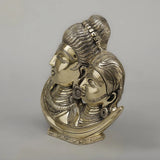 Brass Shiva Parvati face-on moon idol, side view of paired faces with carved jewelry