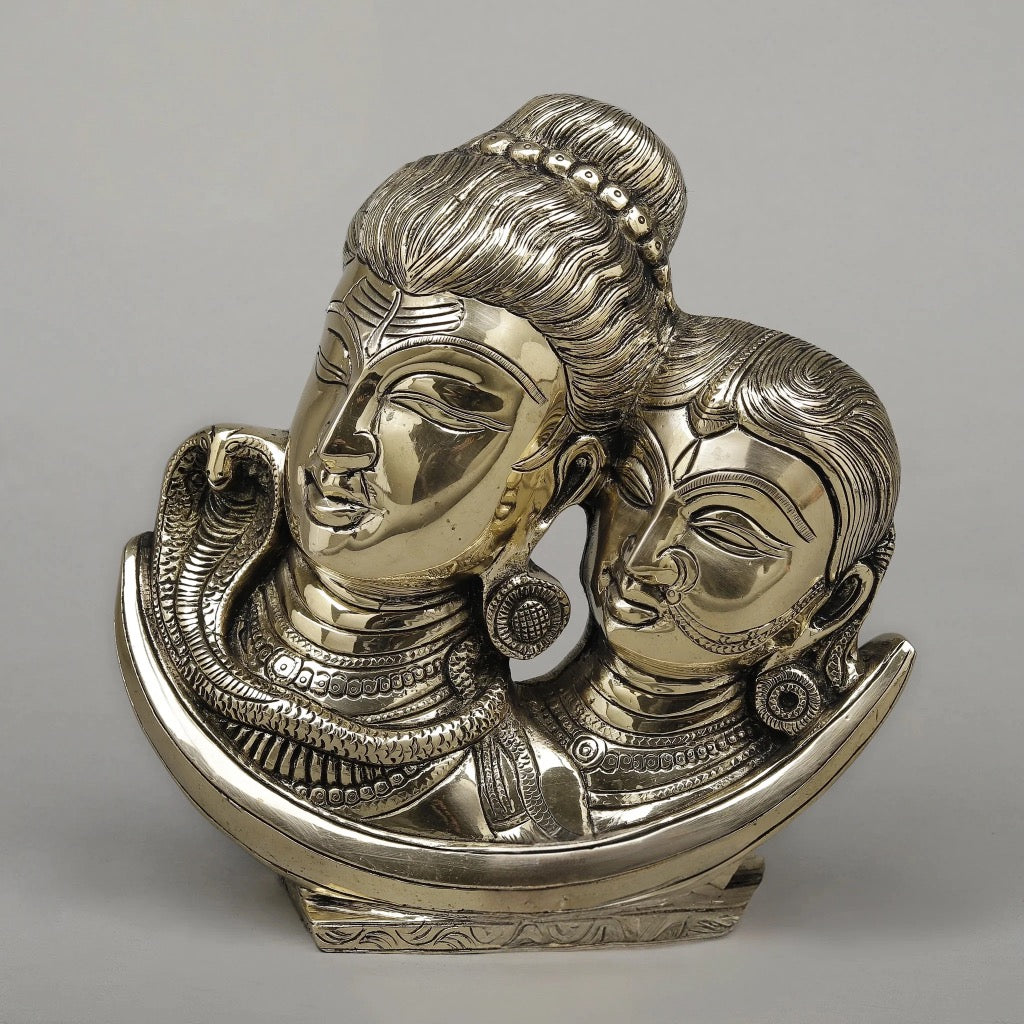 Brass Shiva Parvati face-on moon idol, two detailed faces with jewelry on crescent base