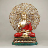 Seated Buddha statue with tree canopy, red robe, green base, gold-tone accents