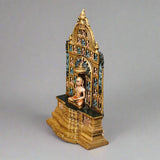 12-inch brass Mahavir Swami idol, side view of seated figure within painted gate
