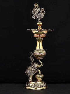Brass peacock lamp with engraved stand, peacock finial, and ornate elephant base
