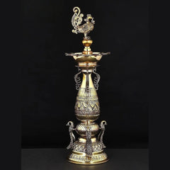 Brass peacock designer lamp with ornate standing base and finial, height 16 in