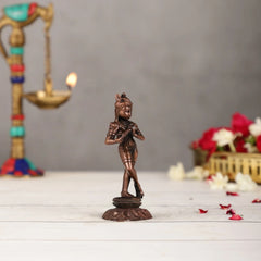Copper Krishna Murti, 4.5 in, front view of dancing figurine holding a flute