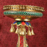 Close-up of pure brass camel urli tray with green inlay, bells, and head ornament