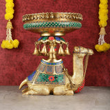 Pure brass camel urli with green patterned base, bells, and detailed saddle blanket