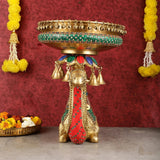 Pure brass camel urli on standing figure with red patterned outfit, bells, and tray