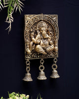 Golden brass Ganesh figure in square frame with three dangling jingle bells