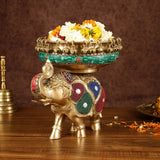 Elephant urli centerpiece: green mosaic bowl with flower-filled top on jeweled brass elephant