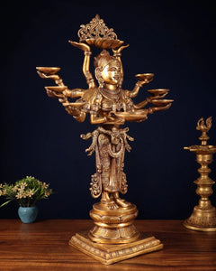 Brass deep lady sculpture with ten arms and decorative robe pattern, seated base
