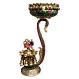 Brass urli diya holder with green enamel rim, peacock figurine and multiple diyas