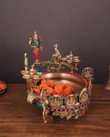 Ashtalakshmi brass urli with diyas, side view with diya cups and orange flowers