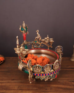 Ashtalakshmi brass urli with diyas, side view with diya cups and orange flowers