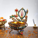 Gold-toned brass urli bowl with multicolored chakra centerpiece and side handles