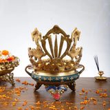 Brass urli bowl with circular base, guardian figures, and multicolor beaded border