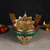 Brass peacock-shaped urli base with cutout top and decorative legs, colorful rim trim