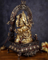 Brass Ganesha statue, front view through arched frame, ornate base and jewelry details