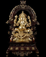 Brass Ganesha statue with ornate arch, seated pose, detailed crown and four arms