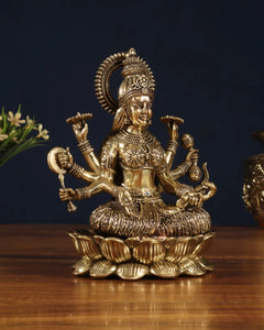 Brass Vijaya Lakshmi idol, three-quarter front: halo arch, multi-armed pose, lotus pedestal