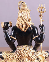 Close-up Lord Shiva brass murti, gold hair and black torso, trident upright