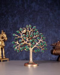 Kalpavriksha tree figurine in pure brass with green stones; round base with red accents