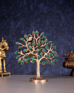 Kalpavriksha tree figurine in pure brass with green stones; round base with red accents