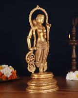 Brass lady statue in draped sari, turned pose holding round ornament, arched frame base