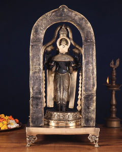 Brass deity idol in arched frame, black robe details and raised hands