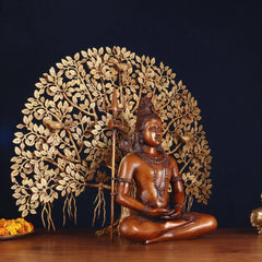 Three-quarter view of seated Lord Shiva holding trident with leafed Kalpavriksha tree