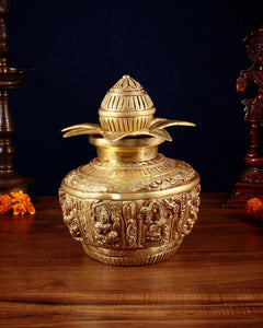 Brass Ashtalakshmi kalash with finial lid and leaf-like accents, detailed panel work