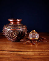 Two brass kalash vessels with carved Ashtalakshmi motifs and gold accents, 11 in