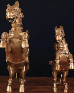 Brass horse statues with ornate helmets and patterned armor, side-by-side view