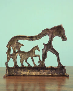 Bronze-toned horse wall hanging with three horse silhouettes and open window cutouts