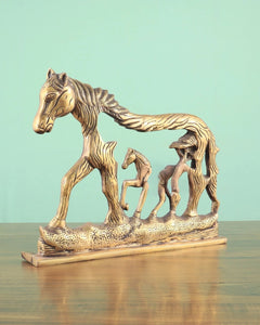 Brass horse wall hanging, angled view of three standing horses with pierced body details