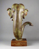 Brass vintage Ganesha face showpiece, full front view on square base.
