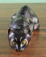 Brass black cat showpiece, front view with green glassy eyes and detailed whiskers