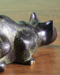 Brass black cat showpiece close-up, carved texture on back and raised head