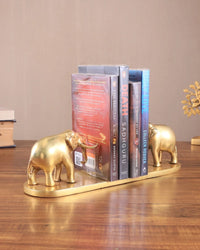 Brass elephant book holder pair supporting books on gold-toned base