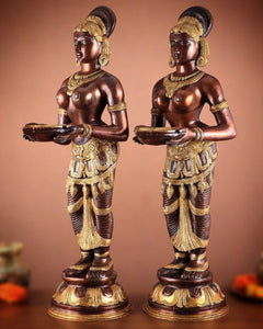 Pure brass lady figurine holding a deepam lamp, angled side view, ornate gold work