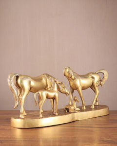 Brass horse family sculpture with horses standing together on oval base