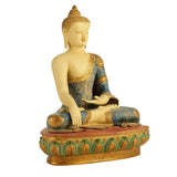 Buddha statue seated cross-legged, blue patterned robe, red base with green details