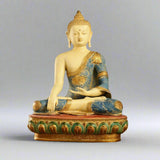 Brass Tibetan Buddha statue, seated, blue-and-gold robe, hand-painted detailing