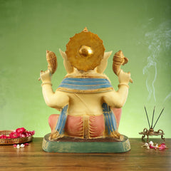 Rear view of brass Ganesha statue, rounded crown and patterned blue shawl over back